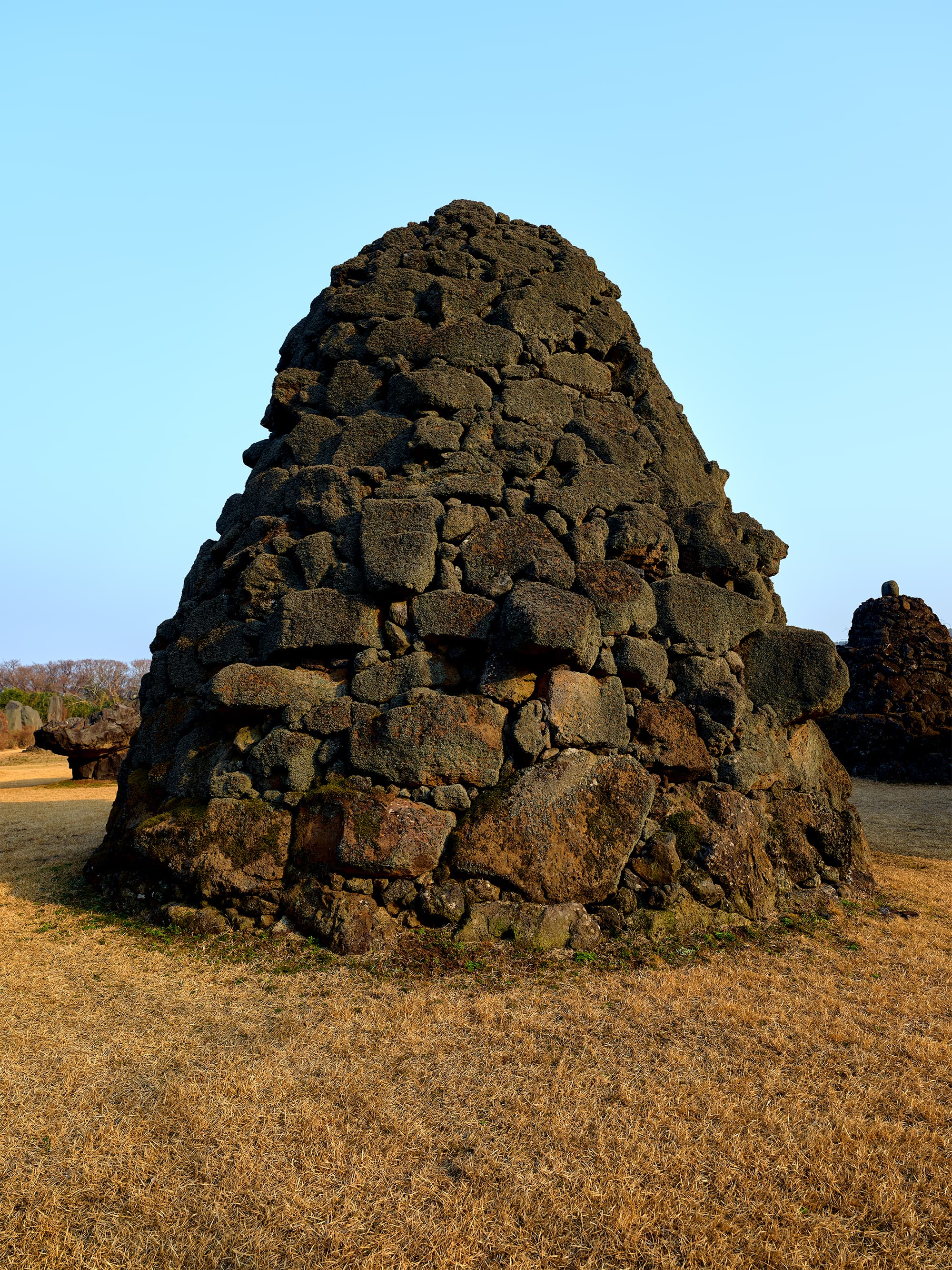 Single large Bangsatap stone cairn against blue sky