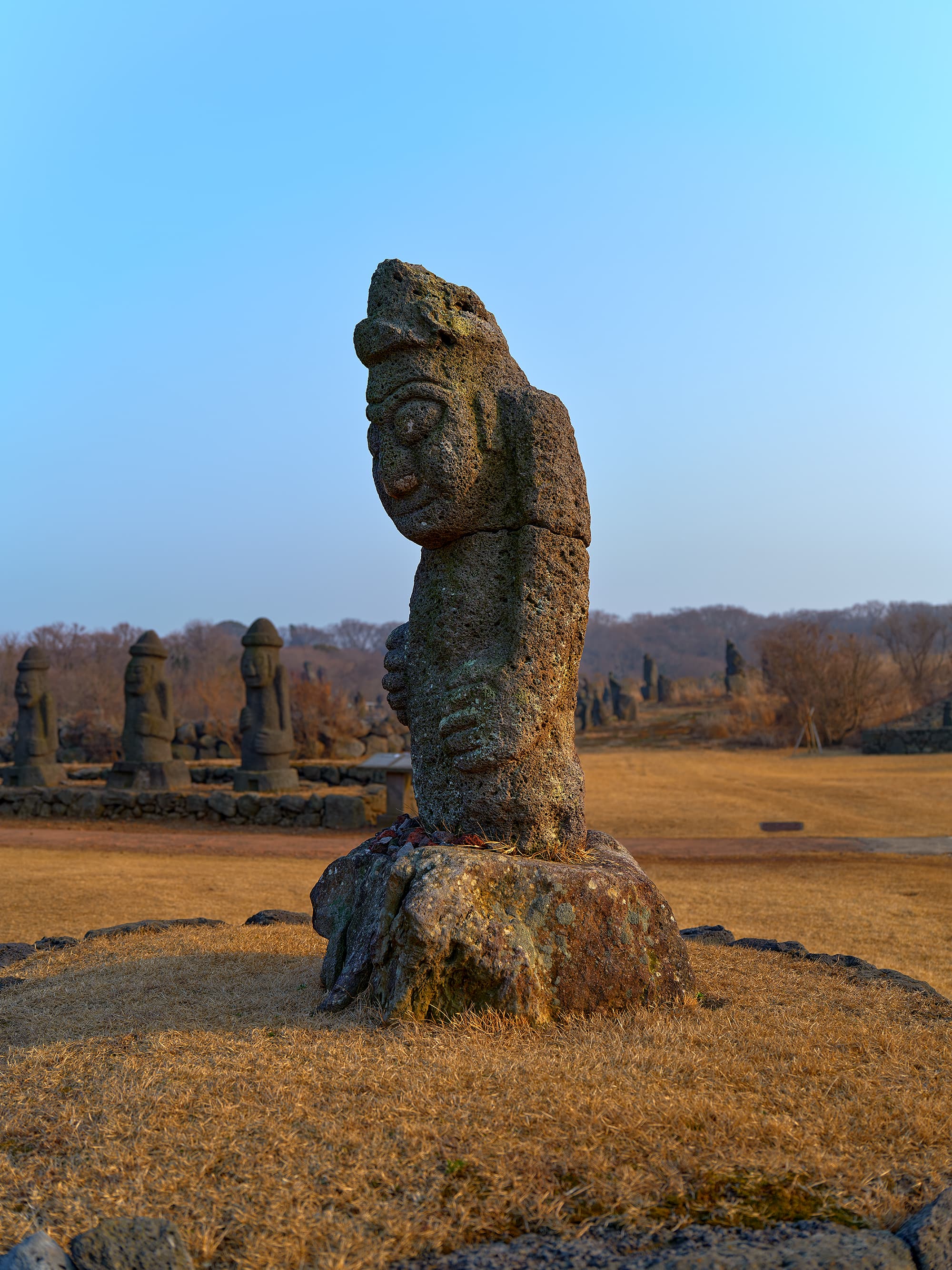 Dolharubang statue standing alone in an open field